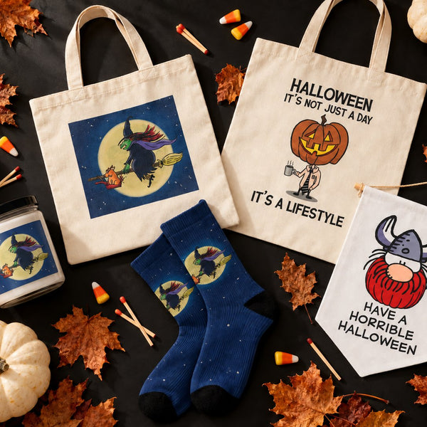 Halloween candles, totes, socks and a pennant from Six Chix, Never Been Deader and Hagar the Horrible, laid out with pumpkins and leaves.