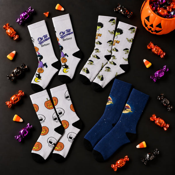 Four pairs of Halloween comic socks from On the Fastrack, Edison Lee, Never Been Deader and Six Chix, spread out like candy.