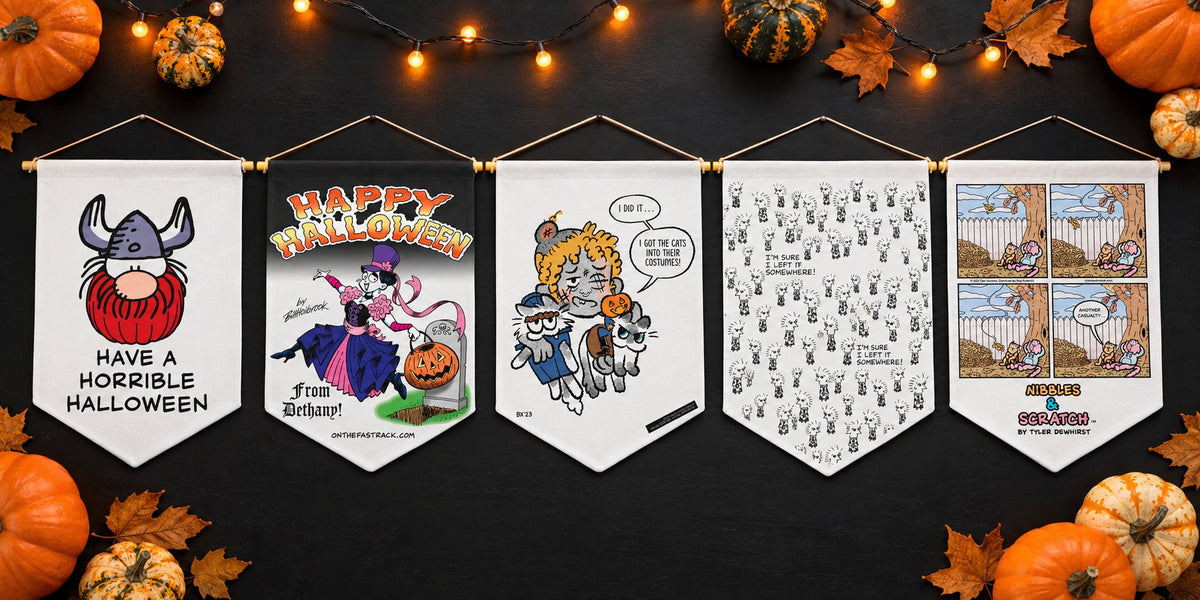 Five Halloween comic strip wall pennants in a row under string lights, from Hagar the Horrible, On the Fastrack, Six Chix, Alice and Nibbles & Scratch.