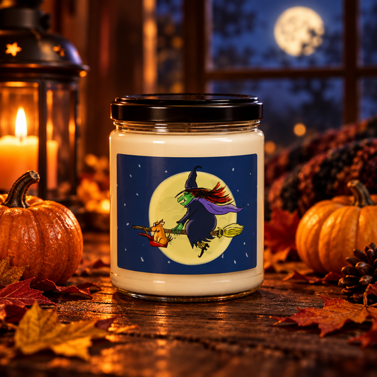 Six Chix Witching Hour soy candle with witch and moon artwork by Susan Camilleri Konar, on a table with pumpkins and autumn leaves.